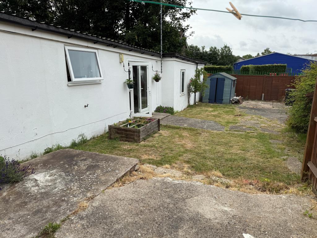 Lot: 161 - DETACHED BUNGALOW IN TOWN CENTRE - View of rear elevation showing garden and shed